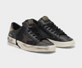 Golden Goose Stardan sneakers in black and gold leather with mesh inserts